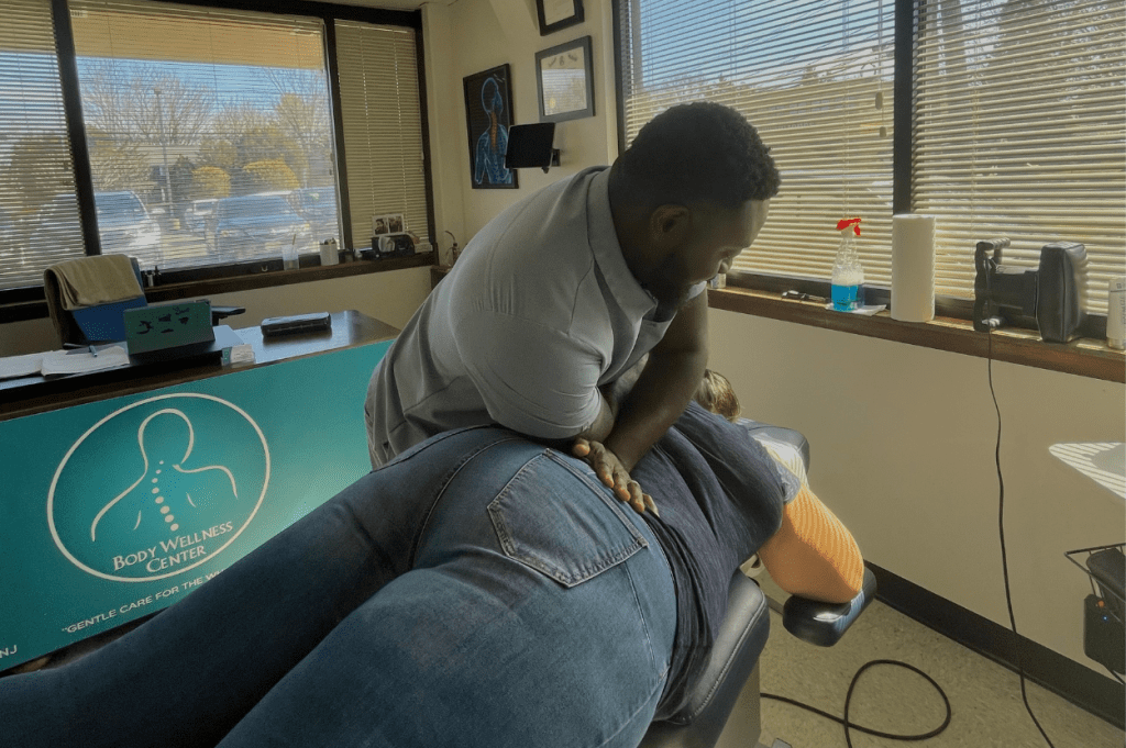Dr. Sackey performs a chiropractic adjustment on a patient at the Body Wellness Center in Northern New Jersey.