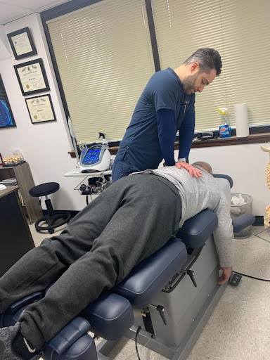 Dr. Sarkis performs a spinal adjustment on a patient at Body Wellness, a chiropractic clinic in northern New Jersey.