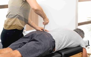 A middle-aged man receives affordable chiropractic services in Northern NJ.