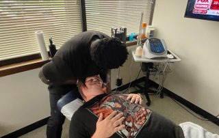 Features Dr. Sackey, chiropractor at Body Wellness Center in Northern NJ, performing chiropractic adjustments on a patient.